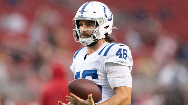Colts long snapper Luke Rhodes holds a football in his left hand.